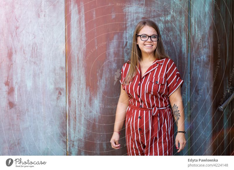 Portrait of a young woman in front of grunge wall body positive Overweight Plus Size Model urban city active people young adult casual attractive female happy