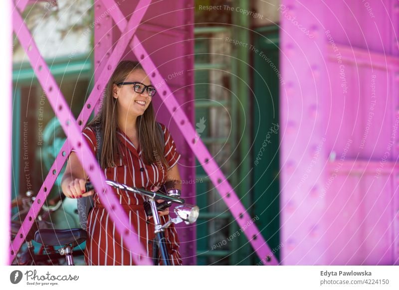 Happy young woman with bike in the city body positive Overweight Plus Size Model urban active people young adult casual attractive female happy Caucasian