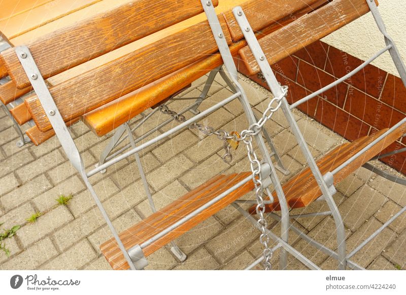 Wooden chairs and table in the beer garden are provided with a chain and a lock / closed Closed Wooden table Beer garden Chair Table Chain Lock Café