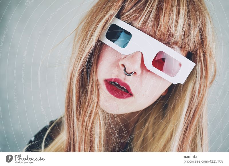 Young woman wearing vintage 3D glasses retro cinema film disposable girl authentic genuine cool fresh piercing red blue many group objects nostalgia past
