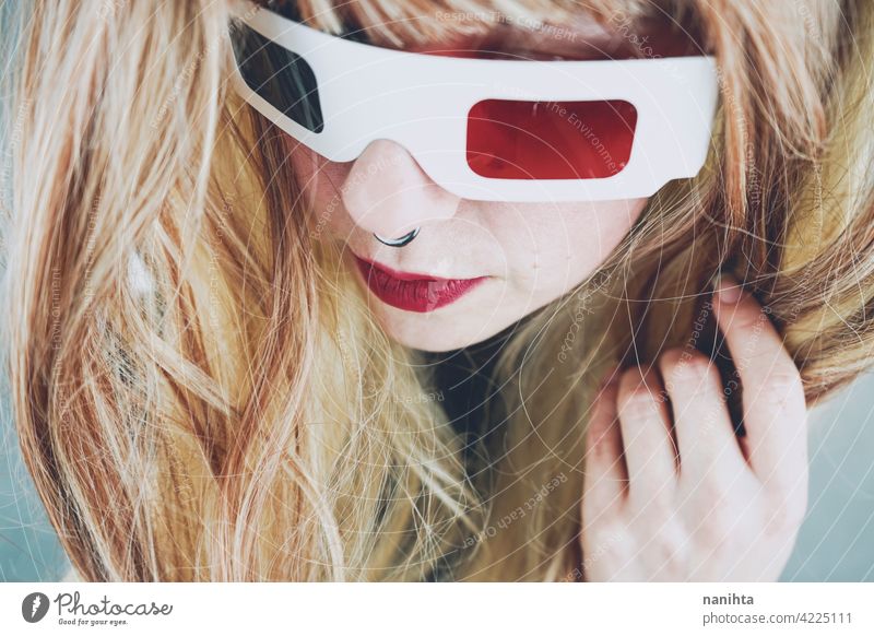 Young woman wearing vintage 3D glasses retro cinema film disposable girl authentic genuine cool fresh piercing red blue many group objects nostalgia past