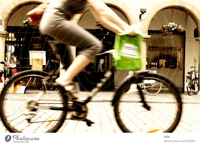 In the city Town Shopping Woman Downtown Middle Speed Mountain bike Paper bag Green Bicycle Transport Cobblestones Arcade Münster Old town Human being Dynamics