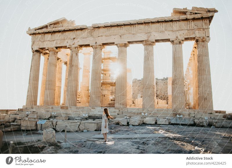 Unrecognizable traveler against Parthenon with stone colonnade in old town parthenon temple architecture classical antique destroy woman sunshine tourist