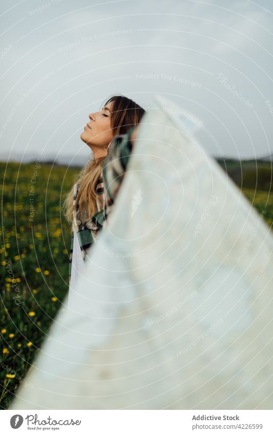 Traveler with paper map and closed eyes in countryside field traveler breathe dreamy eyes closed life trip woman route wanderlust guide lawn tourist natural