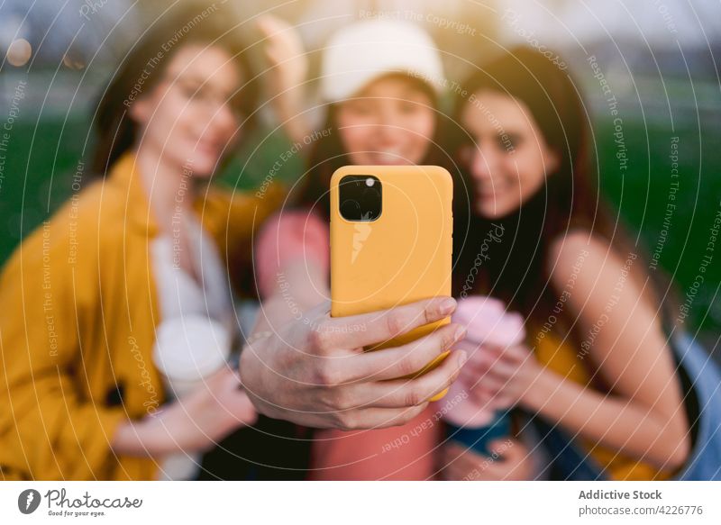 Content girlfriends taking selfie on smartphone in town self portrait memory moment smile spend time weekend city using gadget women best friend style modern