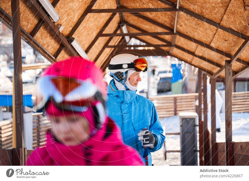 Happy father in helmet and warm activewear in ski resort man cheerful activity warm clothes goggles hobby sport happy smile sunny winter development physical