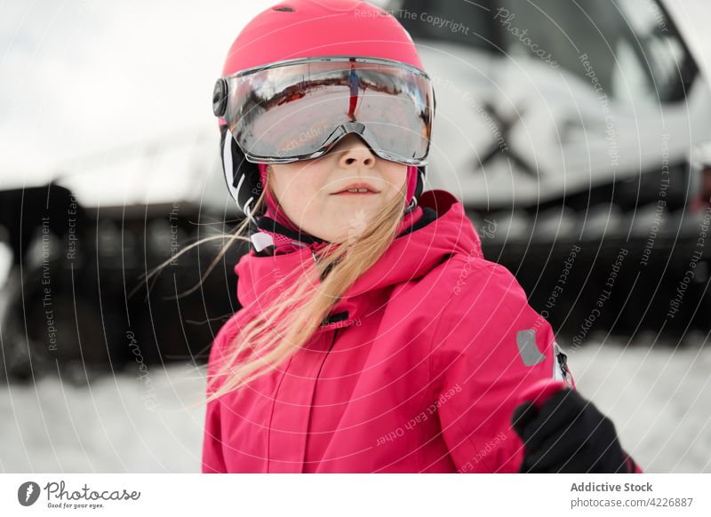 Girl in helmet skiing on snowy slope girl activity activewear sport hobby vitality energy winter development physical skill goggles sporty sportswear