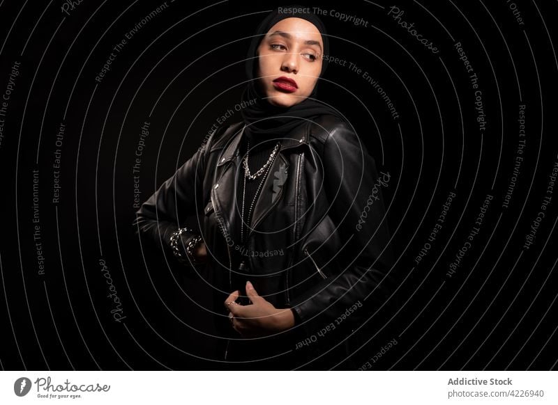 Gorgeous Muslim woman in black headscarf and leather jacket muslim outfit hijab gorgeous style posture culture appearance tradition young feminine islamic calm
