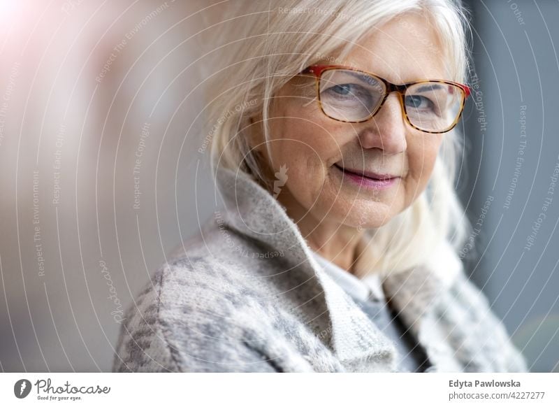 Portrait of senior woman wearing glasses eyeglasses happy smiling enjoying relaxed positivity confident natural seniors pensioner pensioners casual outdoors