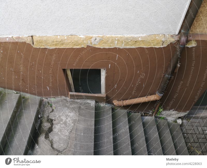 Old grey staircase into the cellar of a run-down old building in the main street in Oerlinghausen at Hermannsweg near Bielefeld in the Teutoburg Forest in East Westphalia-Lippe