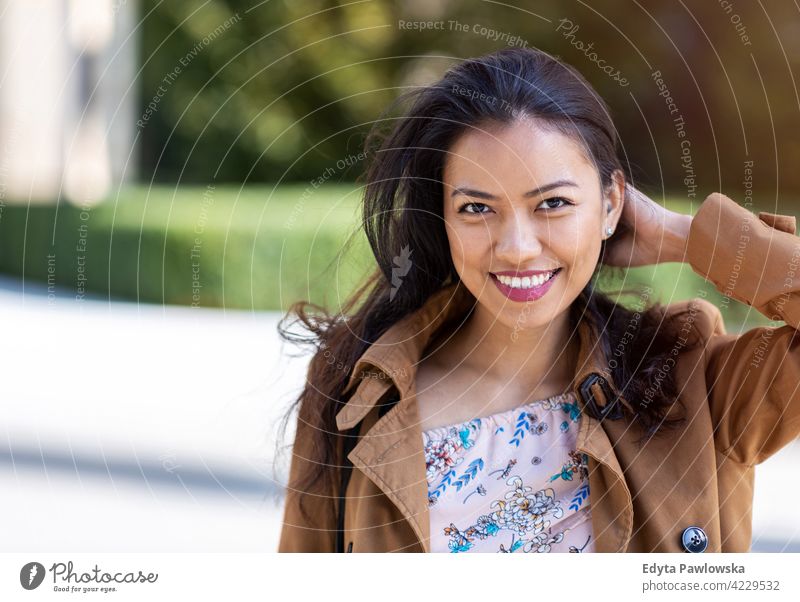 Portrait of beautiful young woman in urban area Filipino street city active people young adult casual attractive female happy asian enjoying one person