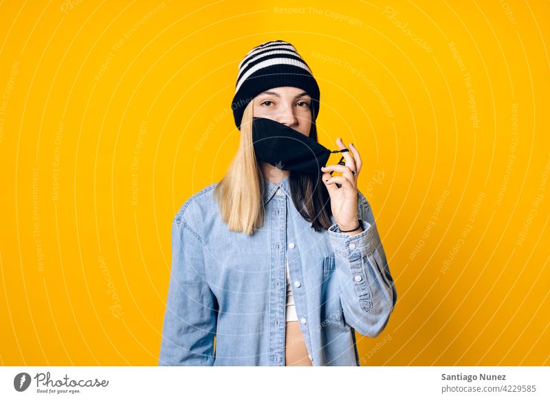 Girl Wearing Face Mask Portrait taking off coronavirus protection new normal new normality cover covering face mask covid19 safety pandemic studio