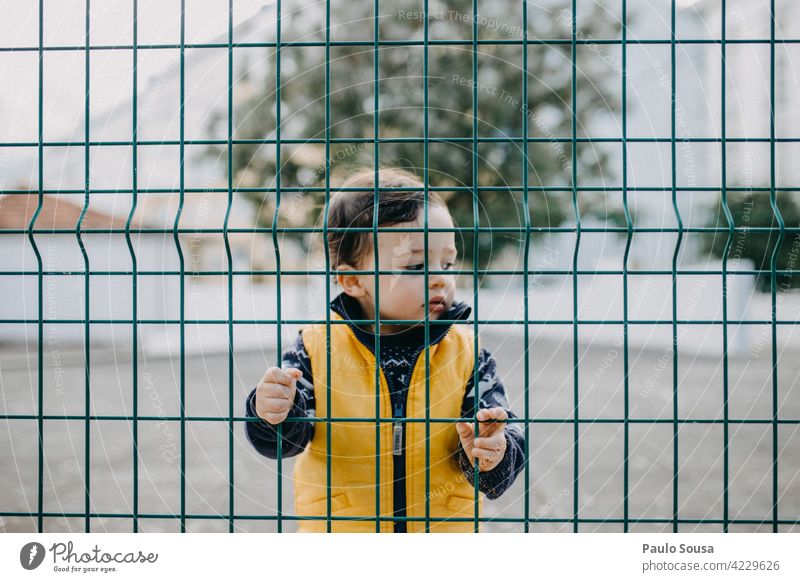 Child behind fence 1 - 3 years Boy (child) Behind Fence Barrier Masculine Exterior shot Toddler Human being Colour photo Day Portrait photograph School