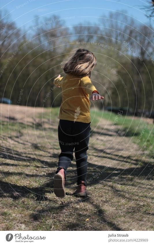 Girl running on a dirt road Running Romp Playing Flying Dream Field Meadow off the beaten track Nature be out Spring Arable land Edge of the forest
