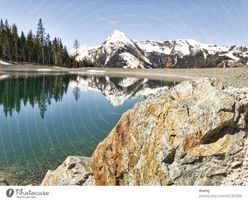 Schoberspitze reflected in the mountain lake. With rocks in the foreground. reflection Loneliness Anticipation Hope Tourism Mountain Sky Clouds Alps Rock Light
