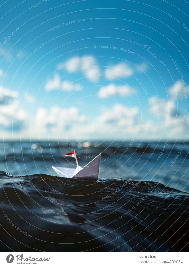 Small paper ship on a big wave voyage travel Vacation mood Swell vacation Sunset Glimmer glossy bokeh paper boat Passenger ship Summer Sailing Waves Beach