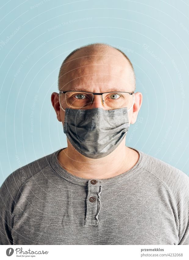 Man patient with face mask. Wearing coronavirus covid-19 protection medical mask during the pandemic person male disease health care hygiene copy space man