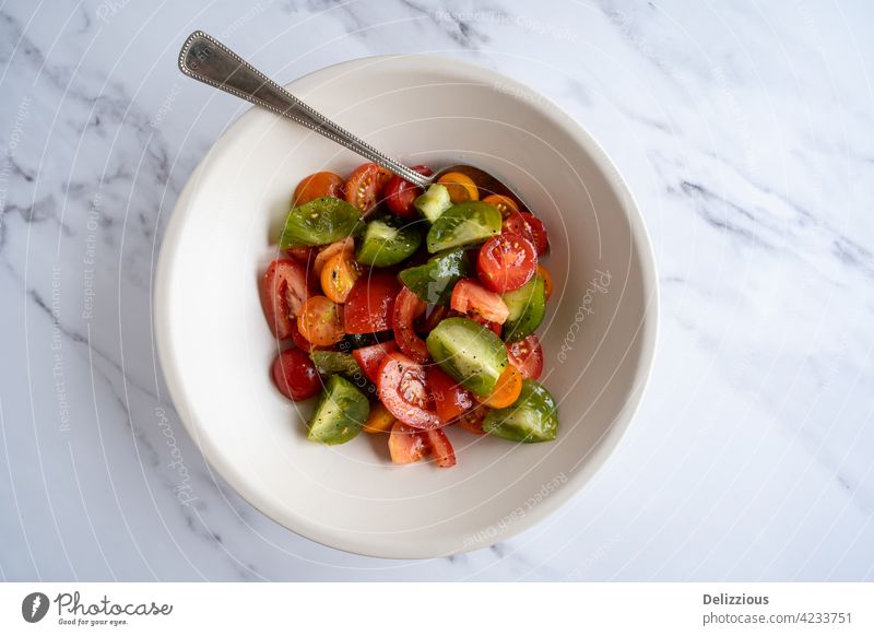 Flat-lay of a fresh colorful tomato salad in a white bowl, vegan, vegetarian food tomatoes photography eat cook chef tasty beautiful spoon cooking summer spring