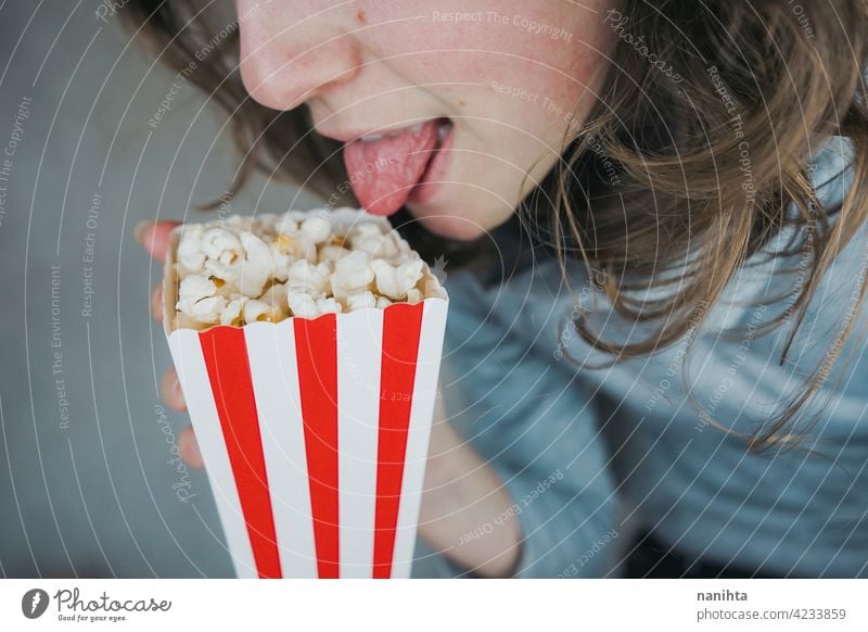 Woman holding a container full of pop corn cinema film vintage retro classic classy red white temptation snack woman enjoy hand lifestyle people food delicious