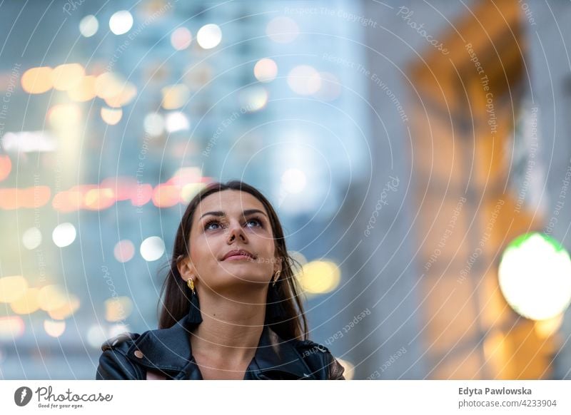 Portrait of young woman in the city at night urban street active people young adult casual attractive female happy Caucasian enjoying one person beautiful