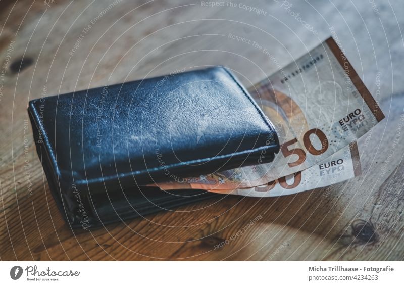Wallet with euro notes on the table portmonee Money Bank note Euro bill Euro symbol Value Cheap Poverty Paying Shopping Save Rich Tight-fisted Luxury