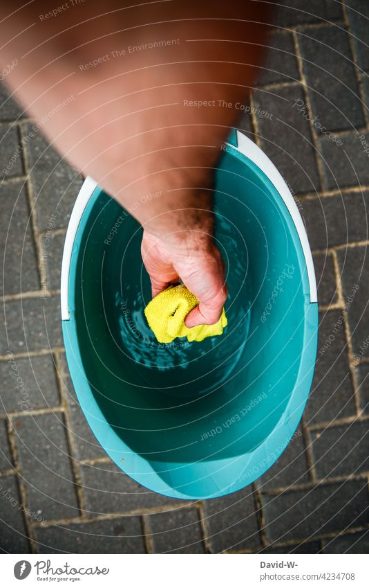 cleaning - hand reaches into the cleaning bucket cleaning day Bucket Hand stop rag cleaning rags Water do the cleaning Cleaning Diligent polish