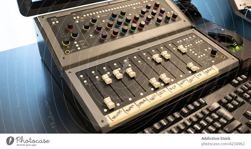 Professional sound mixer on desk in recording studio audio panel control button professional music equipment device mixing console level volume board console