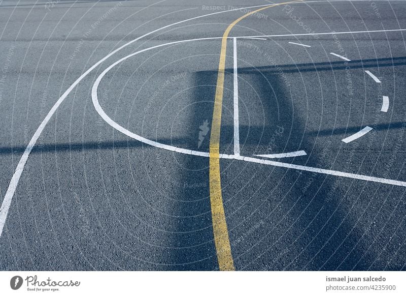 shadows on the street basket court basketball sport field empty lines markings ground play playing old park playground outdoors background bilbao spain gray