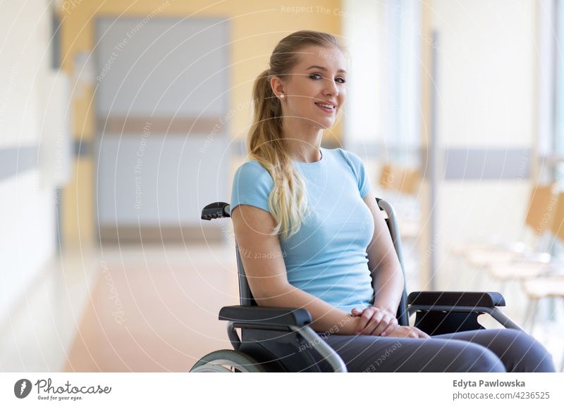 Portrait of young woman sitting in her wheelchair wheel chair disability physical impairment Handicapped mobility support accessibility object handicap disabled