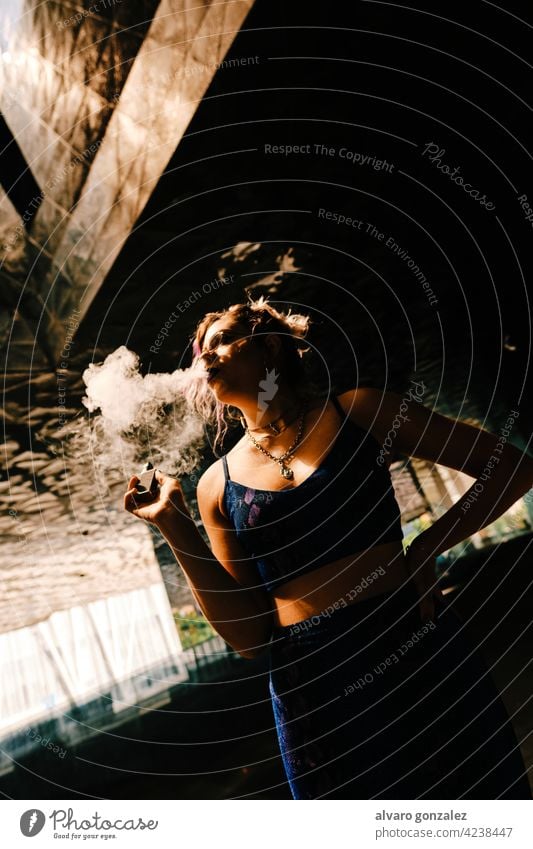 a girl using a vaporizer to eliminate tobacco addiction smoking sensual aspirations smoky smoke smoker alternative woman portrait electronic cigarette beauty