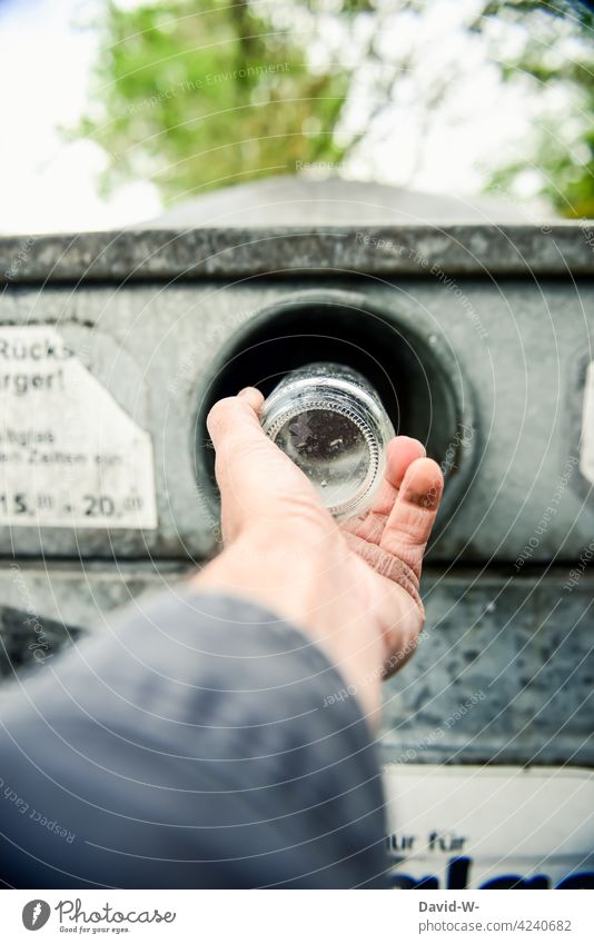 Man throws waste glass into the glass container Glass bin Glass for recycling Trash Dispose of Hand Throw away Recycling waste disposal