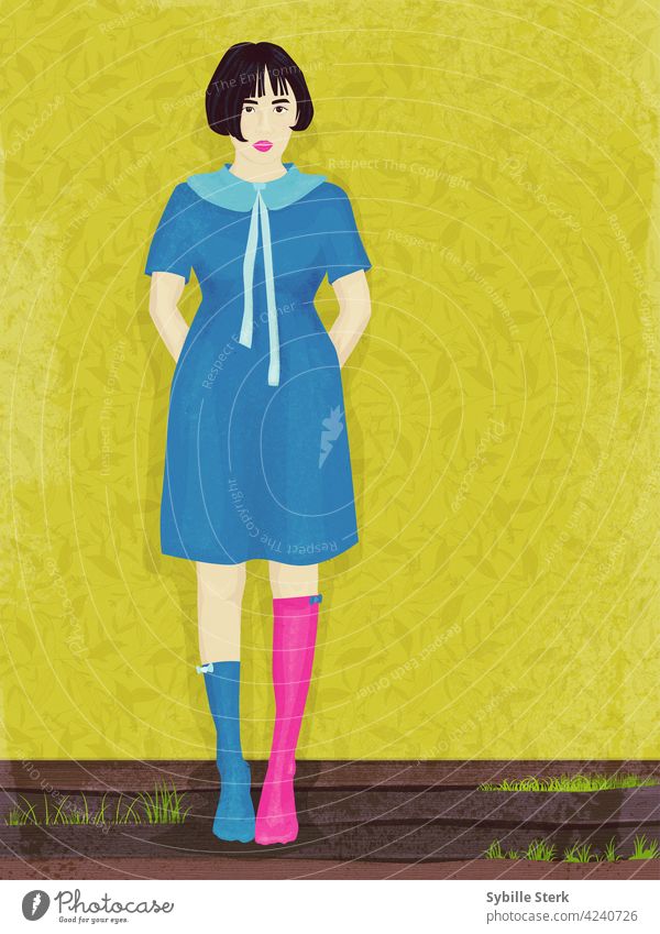Asian girl with two different coloured socks leaning against wall equality racism conceptual wooden floor blue dress young woman pretty girl yellow pink grass