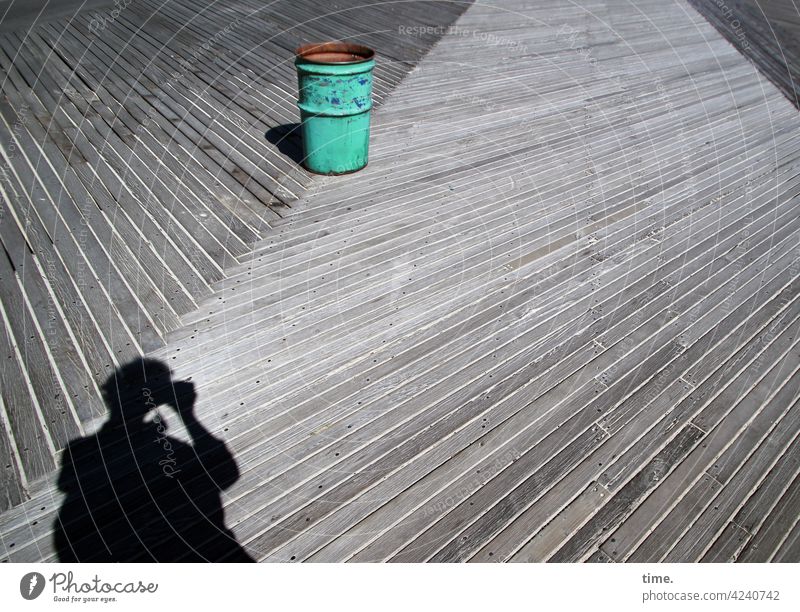 Garbage can on wooden path rubbish clay Photographer Shadow Silhouette Take a photo wooden planks Woodway Diagonal sunny Whimsical green