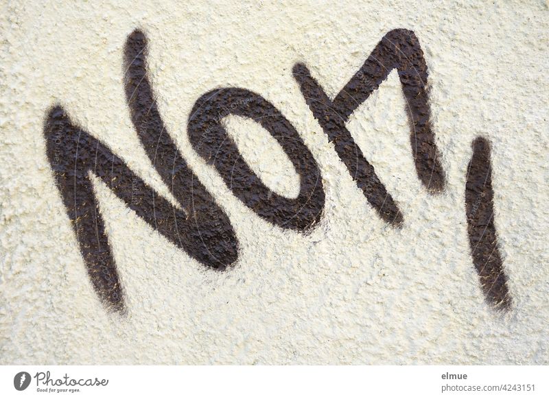 NON is written in black letters on the grey wall non not Graffito writing house wall Wall (building) non-binary nona hora Latin French Gender identity Black