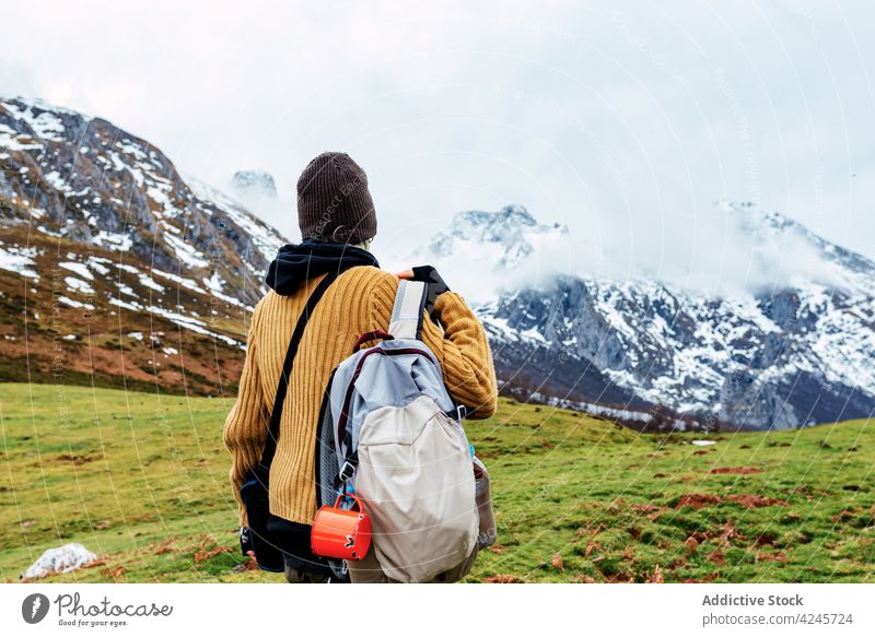 Backpacker on snowy meadow in mountains backpacker traveler valley environment tourism explore vacation scenery tourist hike winter trekking peaks of europe