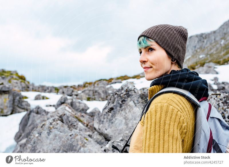Backpacker on snowy meadow in mountains backpacker traveler valley environment tourism explore vacation scenery tourist hike winter trekking peaks of europe