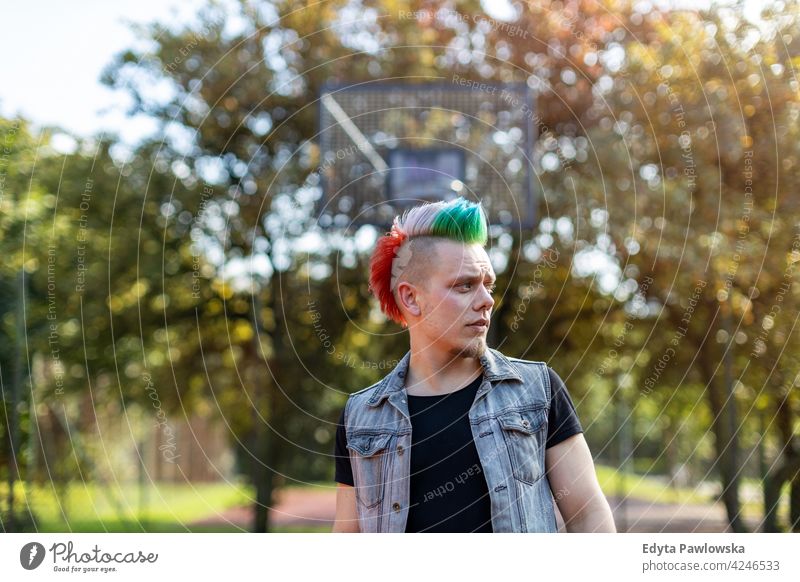 Portrait of a cool young man with colorful mohawk hair portrait adults people one person casual teenage male alone trendy fashion punk style stylish retro