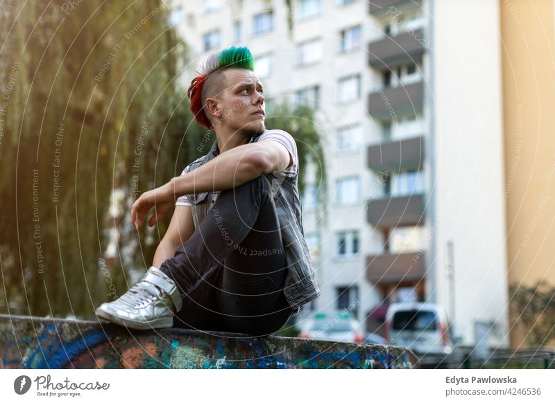 Young punk man on a public housing estates portrait adults young people one person casual teenage male alone trendy fashion cool mohawk hair colorful style