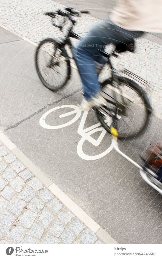 fast passing cyclist with trailer on a narrow bike path in the city, motion blur cyclists cycle path Cycling Cycle path symbol swift Narrow Transport Bicycle