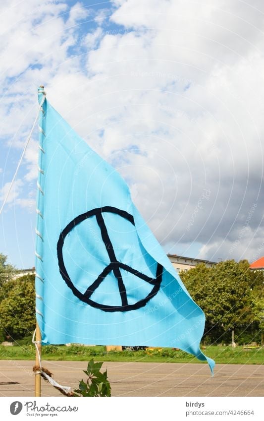 light blue flag with black peace sign, peace symbol Peace Peace-loving Flag Blue pacifism Symbols and metaphors international understanding Sky Clouds