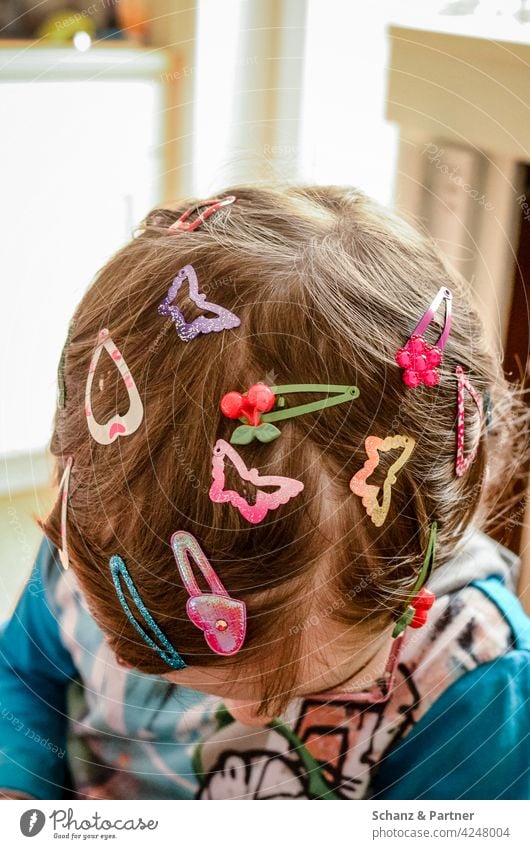 child with many barrettes in her hair - a Royalty Free Stock Photo from  Photocase