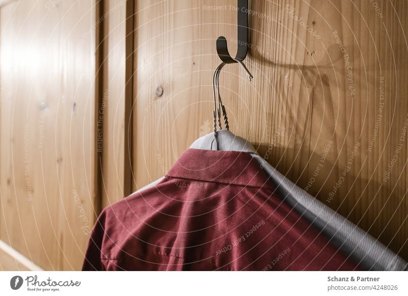 two shirts hanging on the wardrobe Shirts Iron Hanger Closet garments Cupboard prepare Clothing Grasp ironed dresses men's shirts wooden cupboard Checkmark