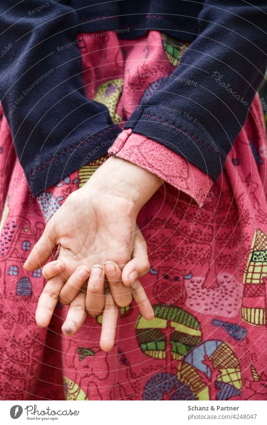 Girl has hands hooked behind her back Dress dirty fingernails Dirty Playing Infancy Sheepish Patient patience Pattern Pink Hand Fingers Close-up family life