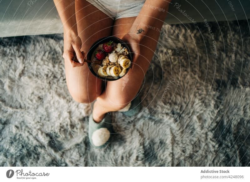Crop unrecognizable woman eating delicious porridge with banana and strawberries fruit enjoy oatmeal breakfast tasty strawberry yummy healthy food sweet fresh
