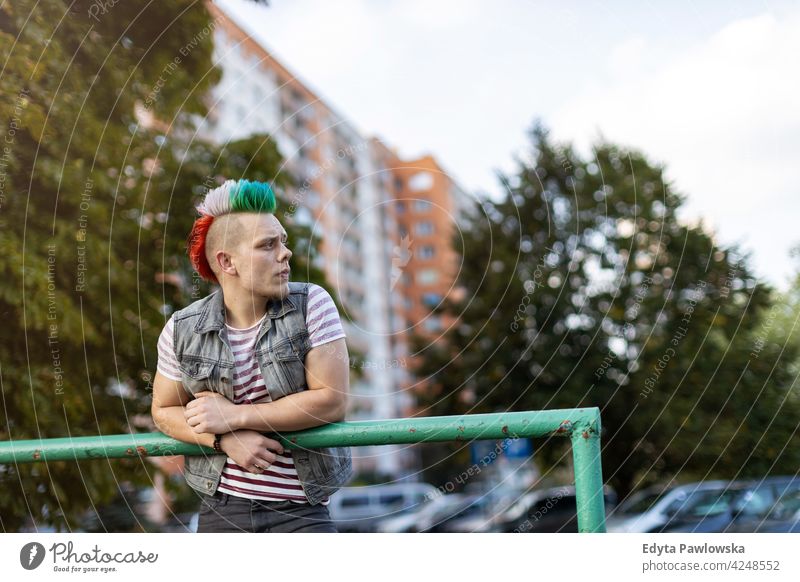 Young punk man on a public housing estates portrait adults young people one person casual teenage male alone trendy fashion cool mohawk hair colorful style