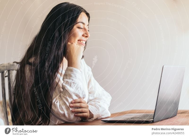 attractive young woman using her laptop in a desk business computer office technology sitting female person work businesswoman beautiful professional girl job