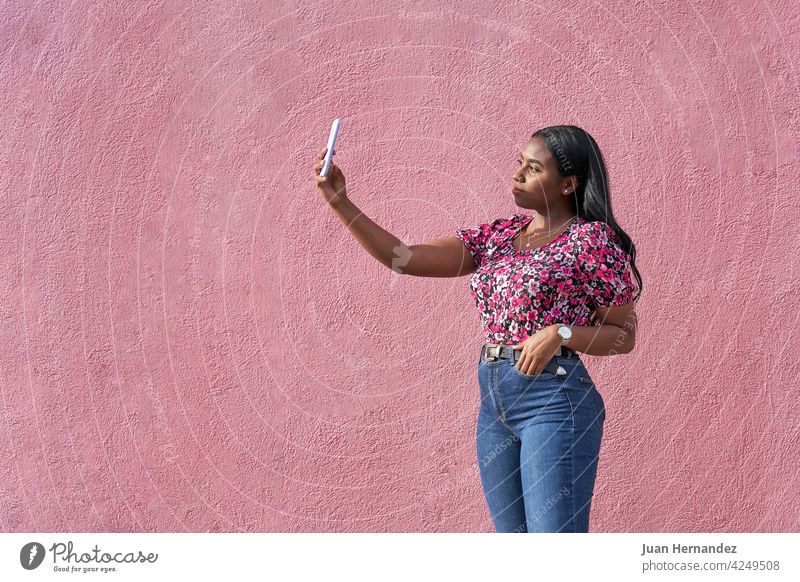 young afro woman taking a selfie with her smartphone beauty african american black woman young adult lady ethnic gesture horizontal copy space copy-space