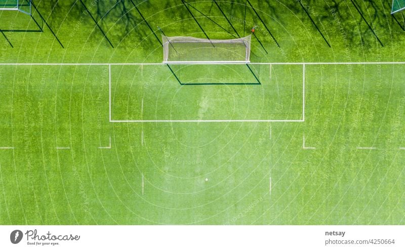 Aerial view of Sport concept of synthetic football or soccer field space with gates and grass background texture and empty space for copy abstract aerial