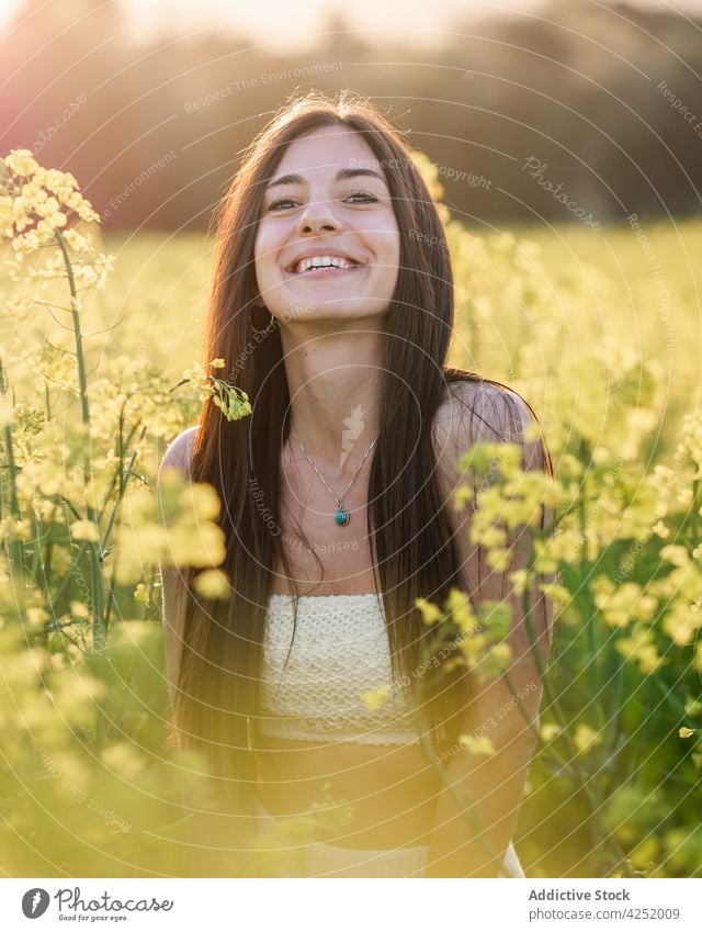 Joyful woman standing on verdant field laugh joyful style blossom summer nature carefree sunny delight rapeseed feminine bloom serene attractive beautiful
