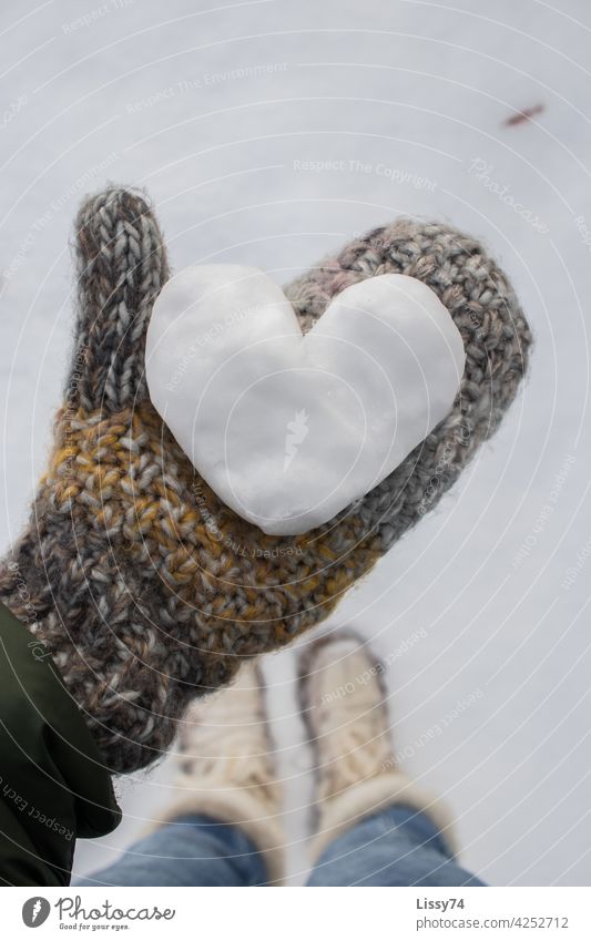A heart formed of snow , held by a gloved hand snow heart Snow Winter Gloves mittens rope woolen gloves variegated hygge Nature Close-up color photograph White